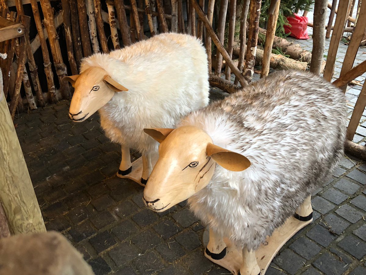 twee houten schapen met een bonte vacht